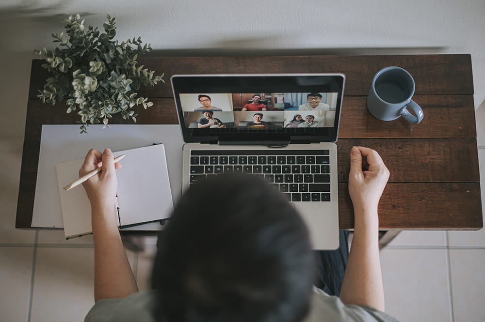 an asian chhinese mid adult woman at her Home Office Video Conference with casual clothing using laptop